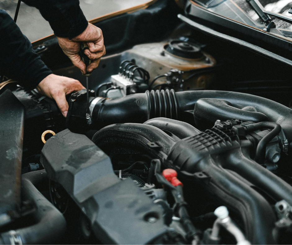 Mechanic Using A Screwdriver To Work On Car Components