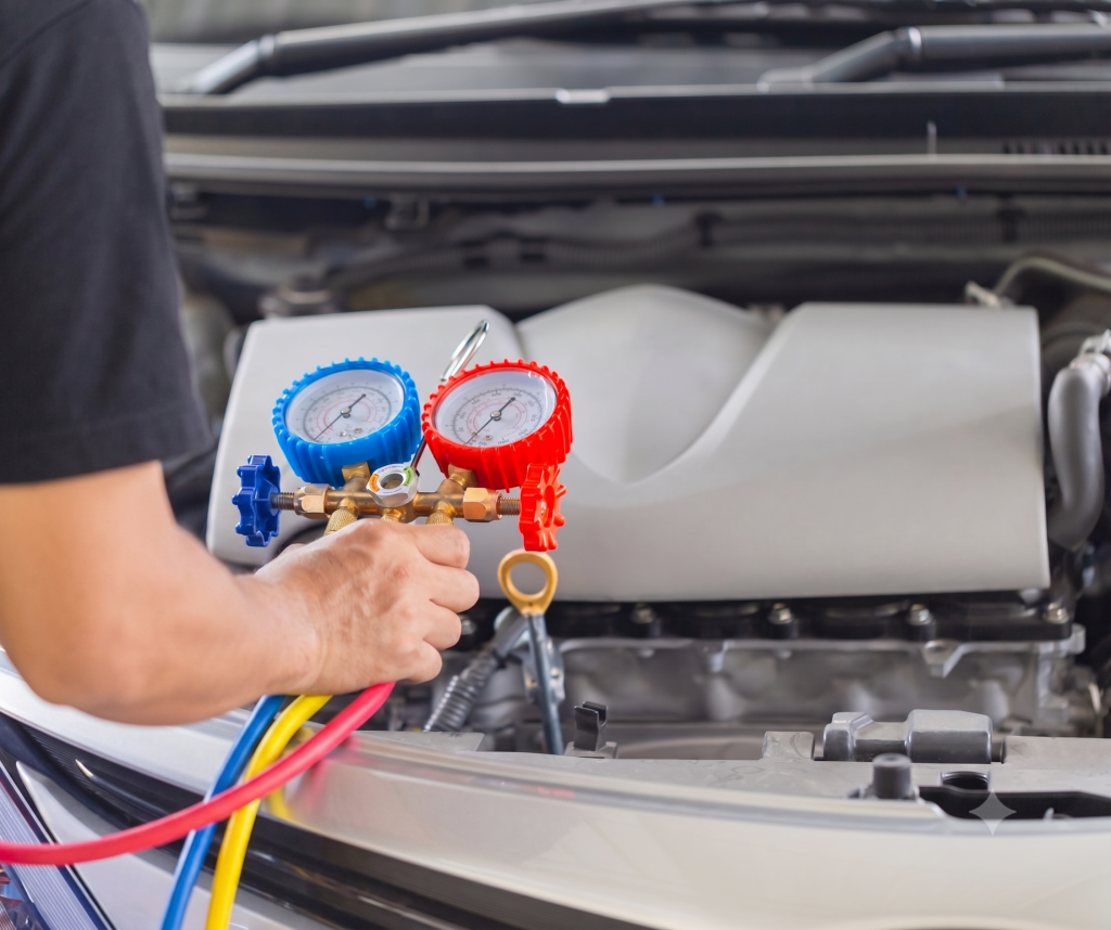 Mechanic Holding An Automotive Manifold Gauge Set