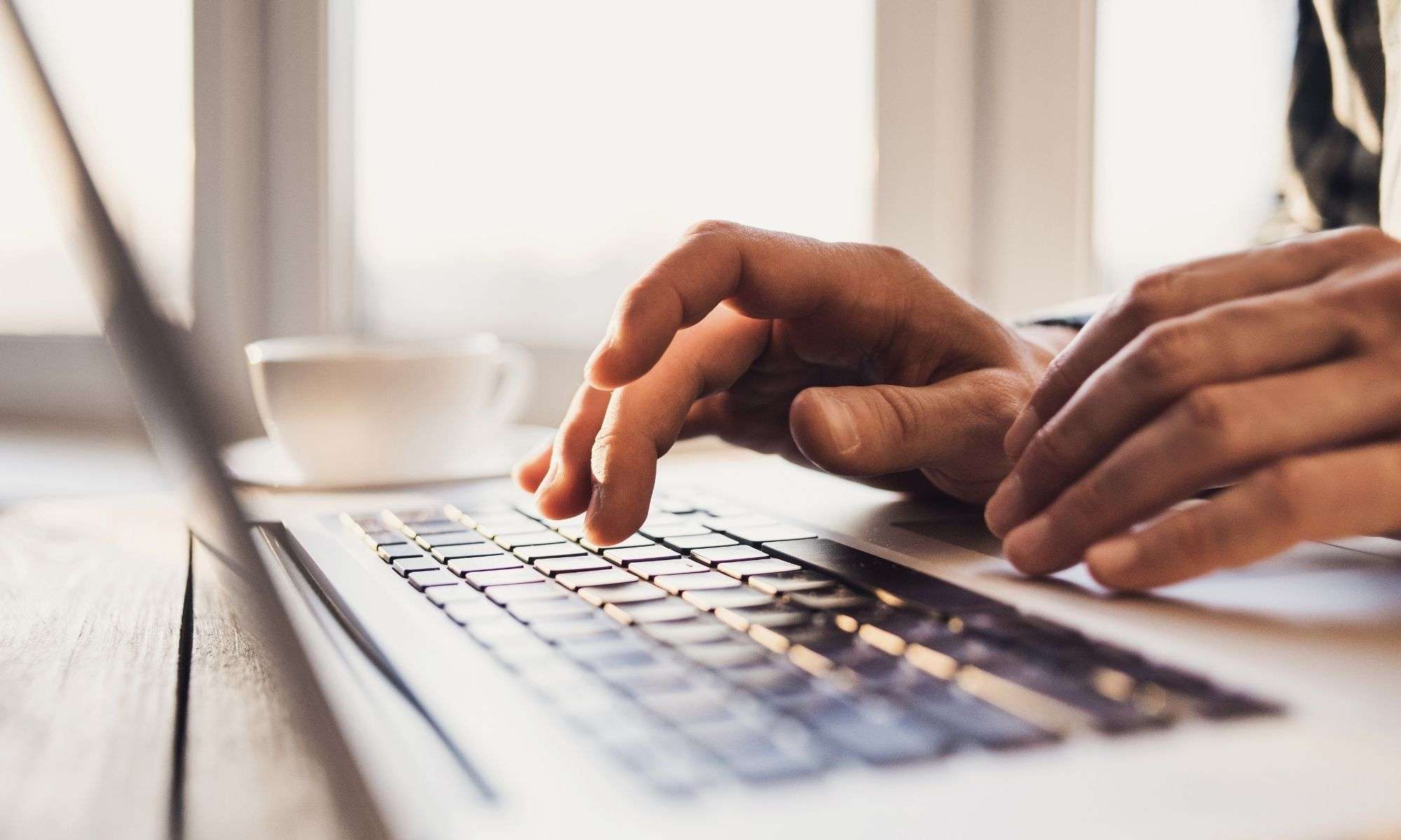 A Person Working On A Laptop